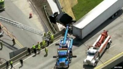 Aerial view of truck dangling from bridge in Michigan