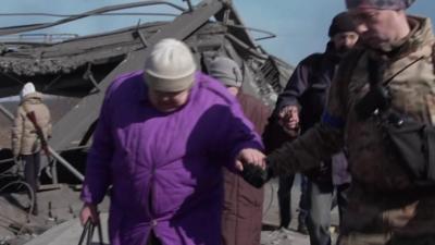 woman holding soldiers hand in Irpin, Ukraine