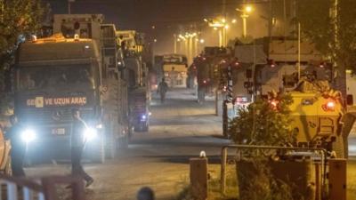 Turkish army soldiers drive towards the border with Syria near Akcakale in Sanliurfa province on 8 October