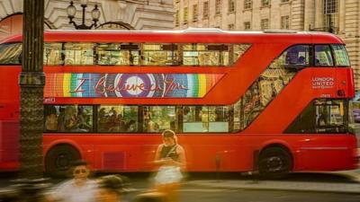 Bus drivers through London on a summers day