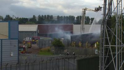 The fire is at a west Belfast glass factory