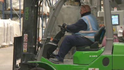 Night worker driving forklift truck