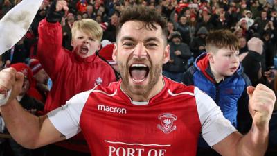 David McDaid celebrates Larne's win over Ballymena United.