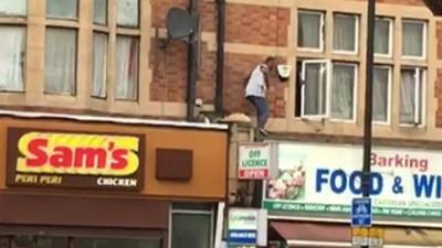 A man on a roof in Barking.