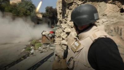 The BBC's Jeremy Bowen watches as a make-shift rocket is fired by Iraqi forces