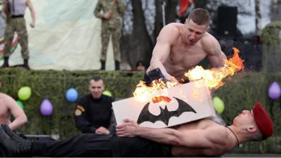 soldier smashing a block of concrete