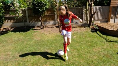 Nottingham Forest Girls FC under-12s player practicing in her garden.