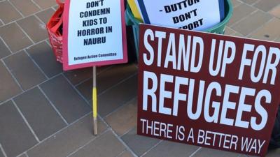 Placards on ground outside Australia High Court following Nauru asylum ruling