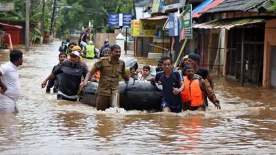 Rescuers evacuate people to in boat