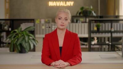 Yulia Navalnaya sitting at a desk speaking