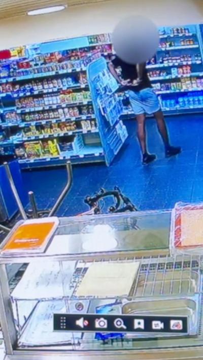 A man putting a can down his shorts.
