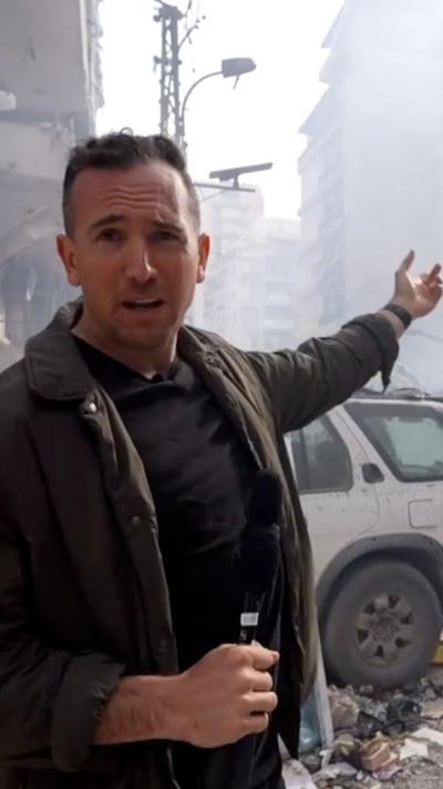 Hugo standing amongst rubble at strike site