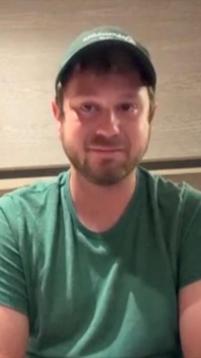 Man wearing green cap and green t-shirt