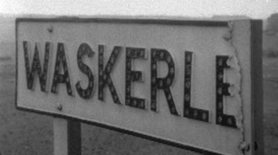 A town sign reading "WASKERLEY", but the last Y has broken off.