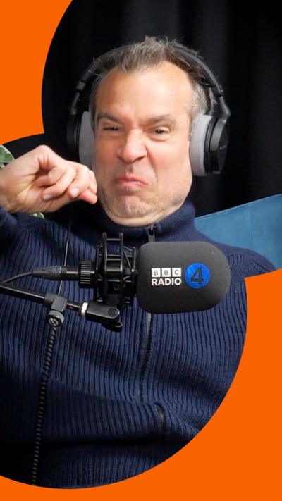 Dr Chris van Tulleken wears black headphones and scrunches up his face as if he was using nasal spray.