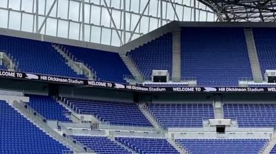 View of a section of blue seats in a football stadium