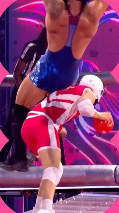 A contestant dressed in red on the programme Gladiators knocks over a contestant dressed in blue