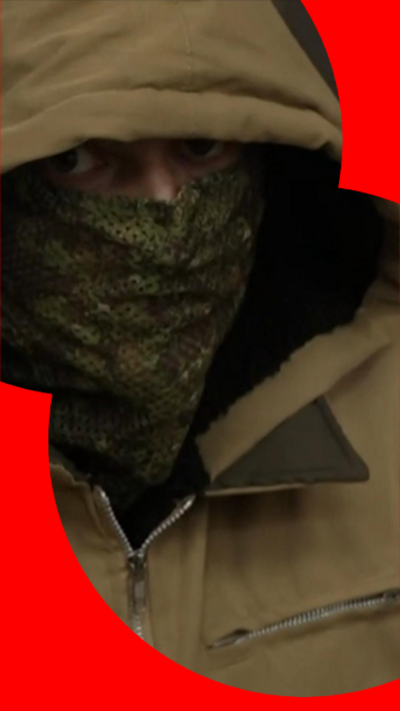 A masked man with a hood up