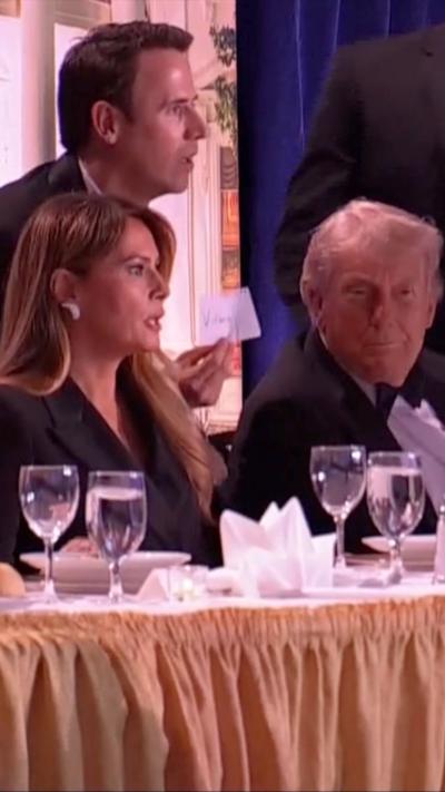 Melania Trump and Oz Pearlman look shocked as they look on next to Donald Trump