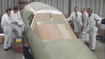 Concorde workers at Filton stand alongside an unfinished Concorde nosecone