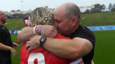 Wales captain Alex Callender and head coach Sean Lynn hug