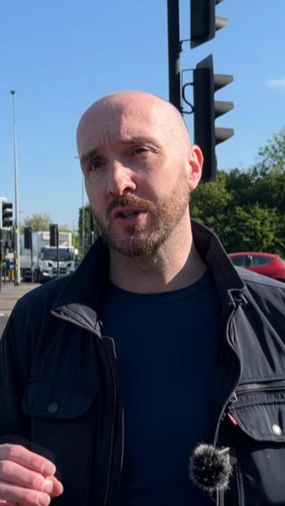 Mike stood in front of traffic lights in Bristol
