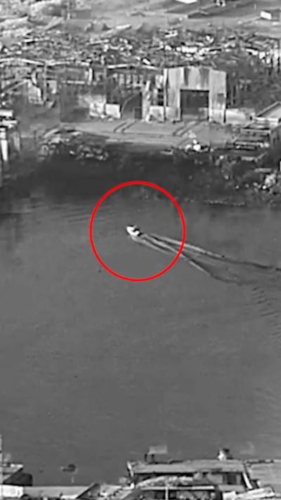 Autonomous water vehicle circled in red in black and white image