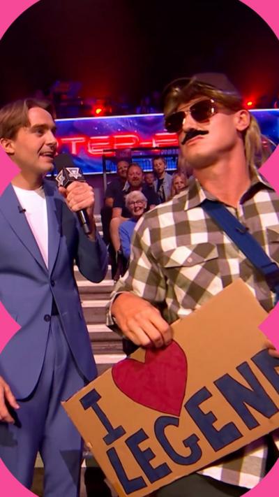 Gladiator Legend wears a costume in the audience with a hat, wig and fake moustache.