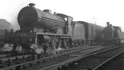 A black and white photo of a steam engine train.