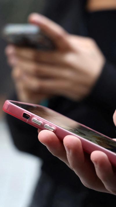 Two smart phones in peoples hands