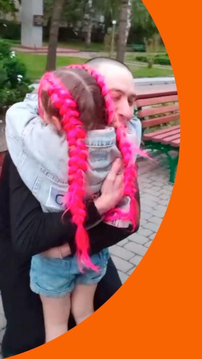 A young girl hugs her father
