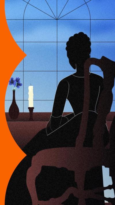 Silhouette of a woman sat at a desk with a candle and a flower in a vase