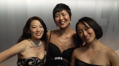 Voice actors for KPop Demon Hunters Rumi, Mira and Zoey pose on the red carpet at the 2026 Oscars.