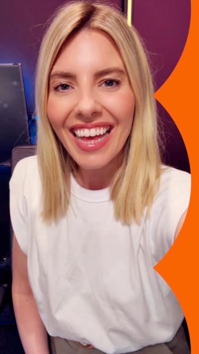 Mollie King, with blonde hair, smiles.