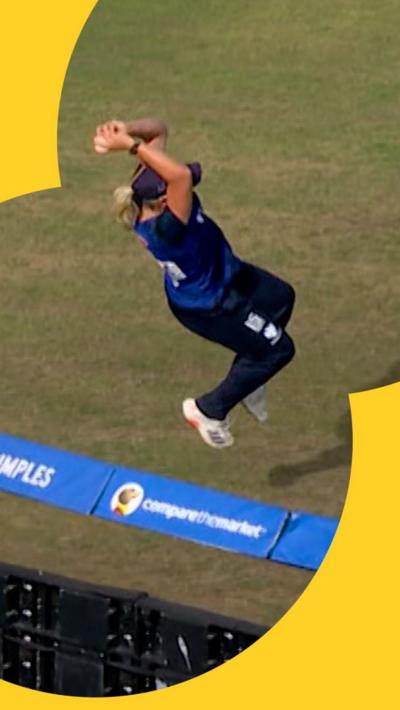 Katie George leaps to prevent a six at the boundary