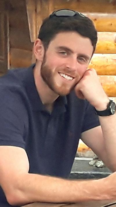 PC Harper smiling with sunglasses on his head
