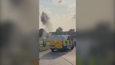 Smoke behind a police van.