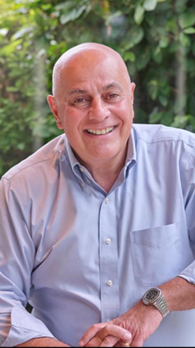 A bald man in a pale blue shirt