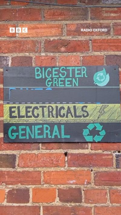 A brick wall with a sign saying Bicester Green