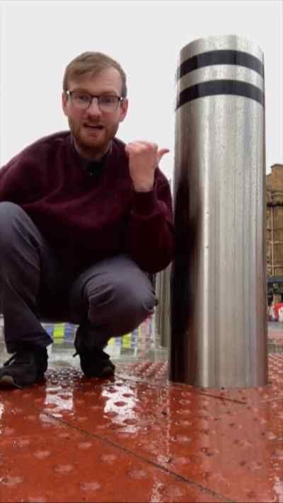 BBC reporter by bollard