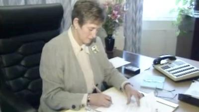 Director general Stella Rimington sits at a desk