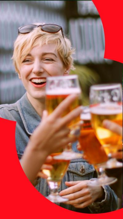 Lady holding up glass of beer and toasting 