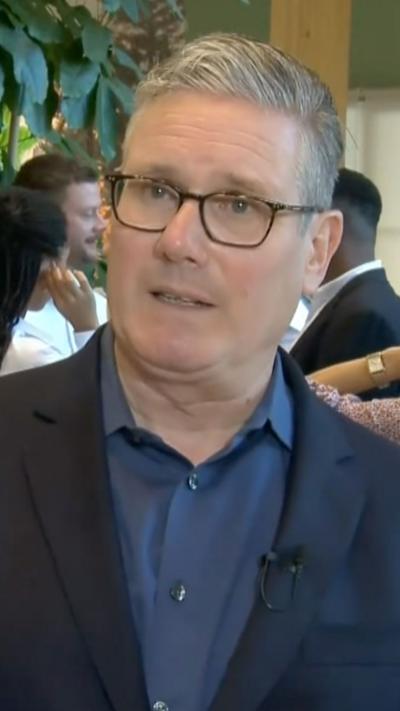 Starmer wearing a navy blue shirt