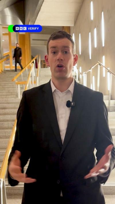 BBC correspondent Phil Sim, a man with short brown hair wearing a white shirt and dark suit jacket