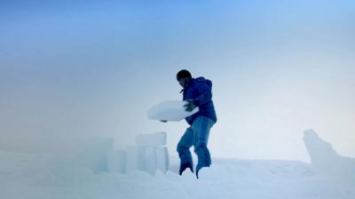 Man building an igloo