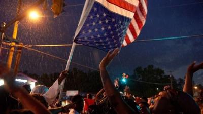 Demonstrators take part in a protest in Ferguson