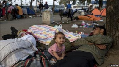 A migrant familly sleeps in a park near the main bus and train station in Belgrade