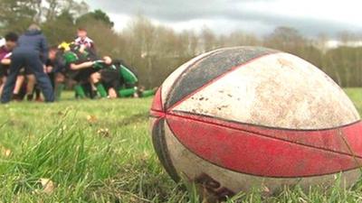 Rugby ball and children playing rugby