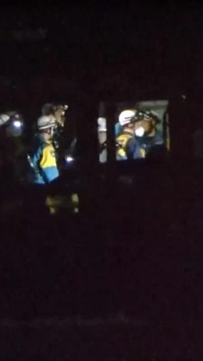 Night time shots showing rescue personnel inside a shopping centre, wearing protective equipment