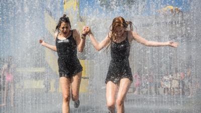 People cool off in a fountain outside the Southbank Centre on June 30, 2015 in London, England